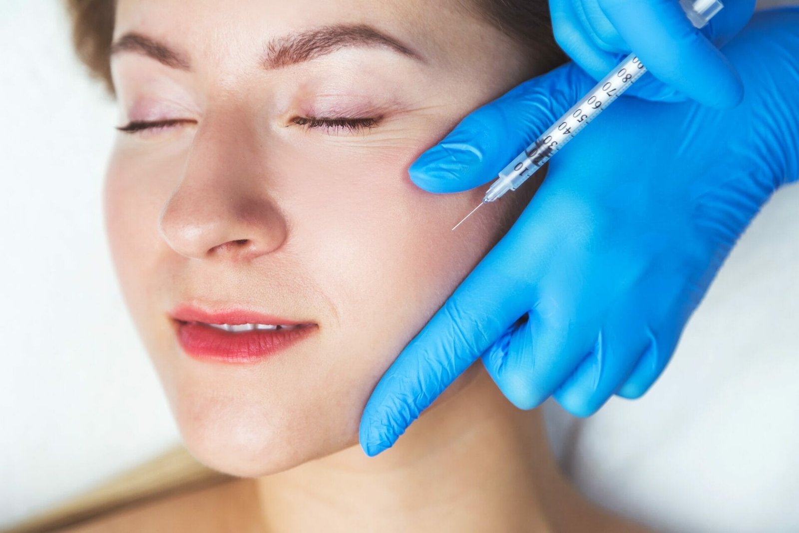 Rejuvenating facial injections procedure for tightening and smoothing wrinkles on the face skin